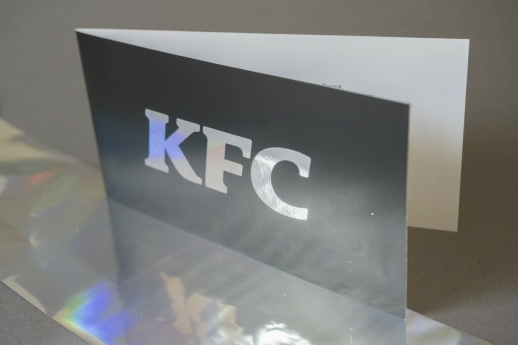 Carte d’invitation Inauguration restaurant KFC – Dorure Argent brillant Numérique – Pelliculage Mat, rainage pliage format paysage – Dorure numérique Rouge sur calque 230g