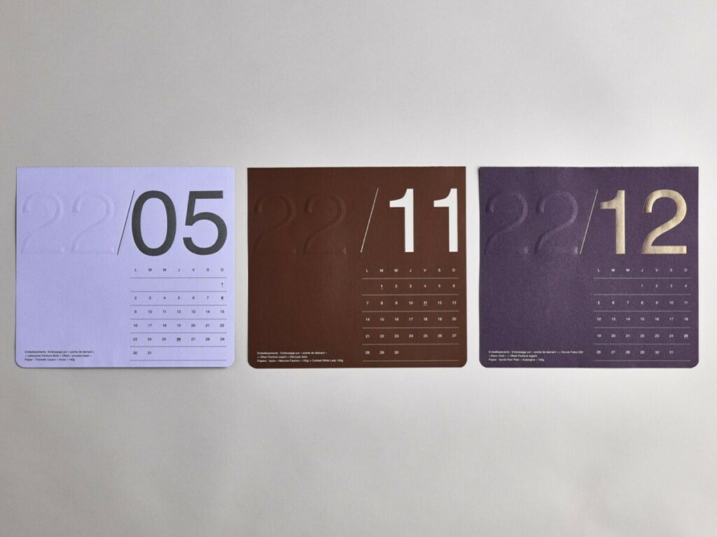 Calendrier collaboratif carré avec reliure Singer à plat et découpe 4 angles arrondis – Materica – Calque – Dorure à chaud – Pantone Argent
