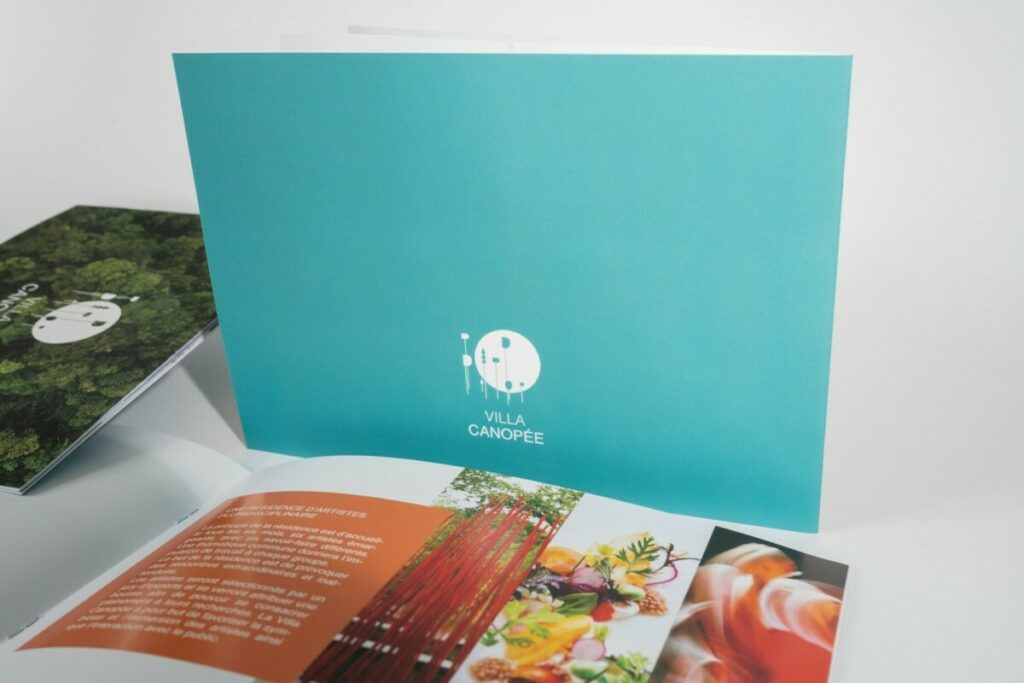 Book de présentation projet résidence d’artiste format A4 paysage – Reliure 2 agrafes métal – Pelliculage soft touch – Vernis 3D sur logo