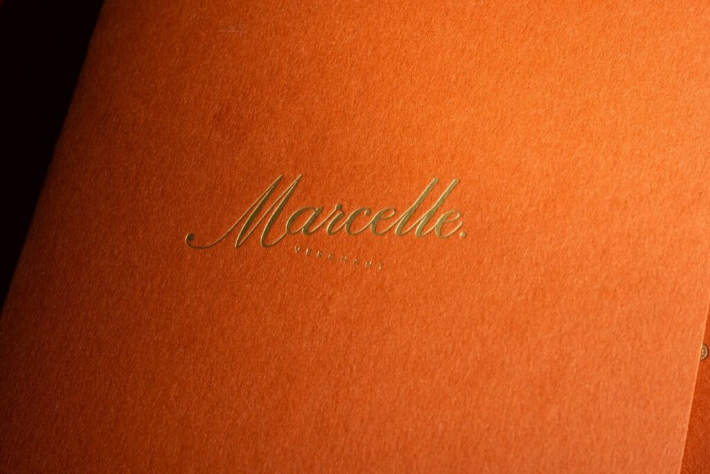Couverture porte menu sur papier terracotta avec marquage à chaud or sable 429 en débossage – Materica Terra Rossa 360gr