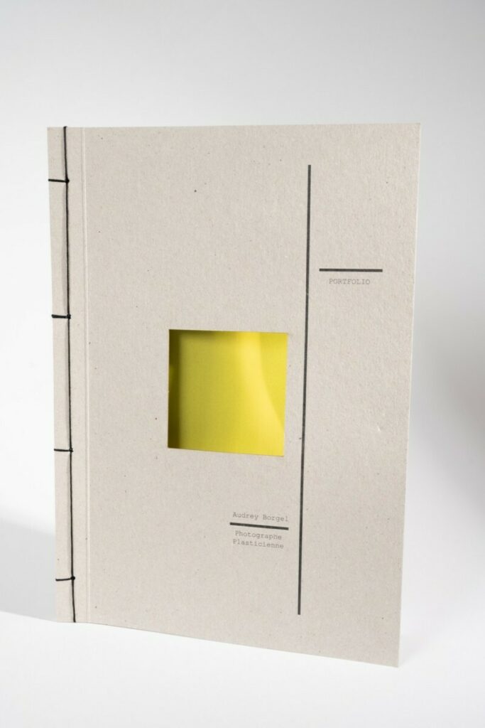 Porfolio pour photographe plasticienne avec reliure en couture Japonaise 4 points – Couverture en carton gris recyclé 350g avec découpe centrale