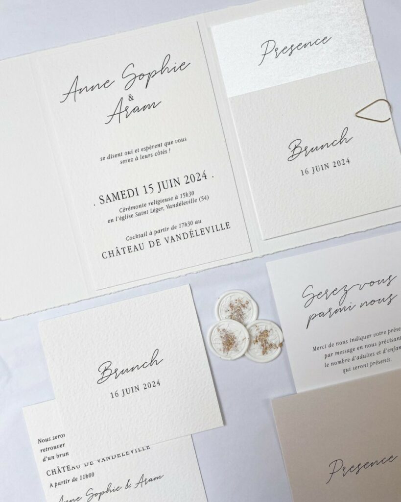 Faire-part de mariage pochette pockart, cachet de cire blanc inclusion feuille d’or et trombone doré – papier texturé Arches Expression – Papier irisé Sirio pearl