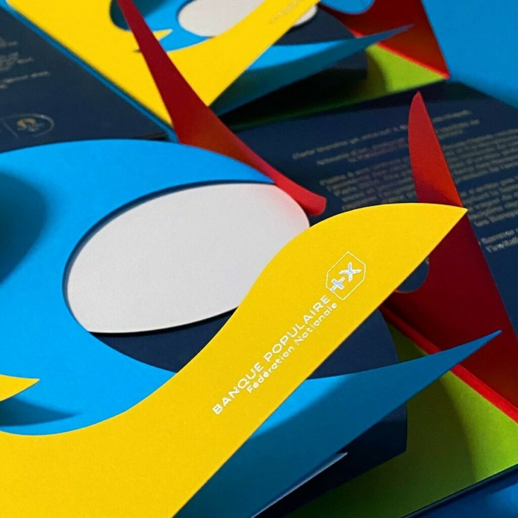 Carte de voeux Jeux Olympiques en papier contre collé et découpe à la forme silhouette – Marquage à chaud argent brilllant – Olin Colours Sunshine Yellow, Cobalt, Poppy, Pistachio, Califronia blue, Brilliant White – Contre collage multi épaisseurs